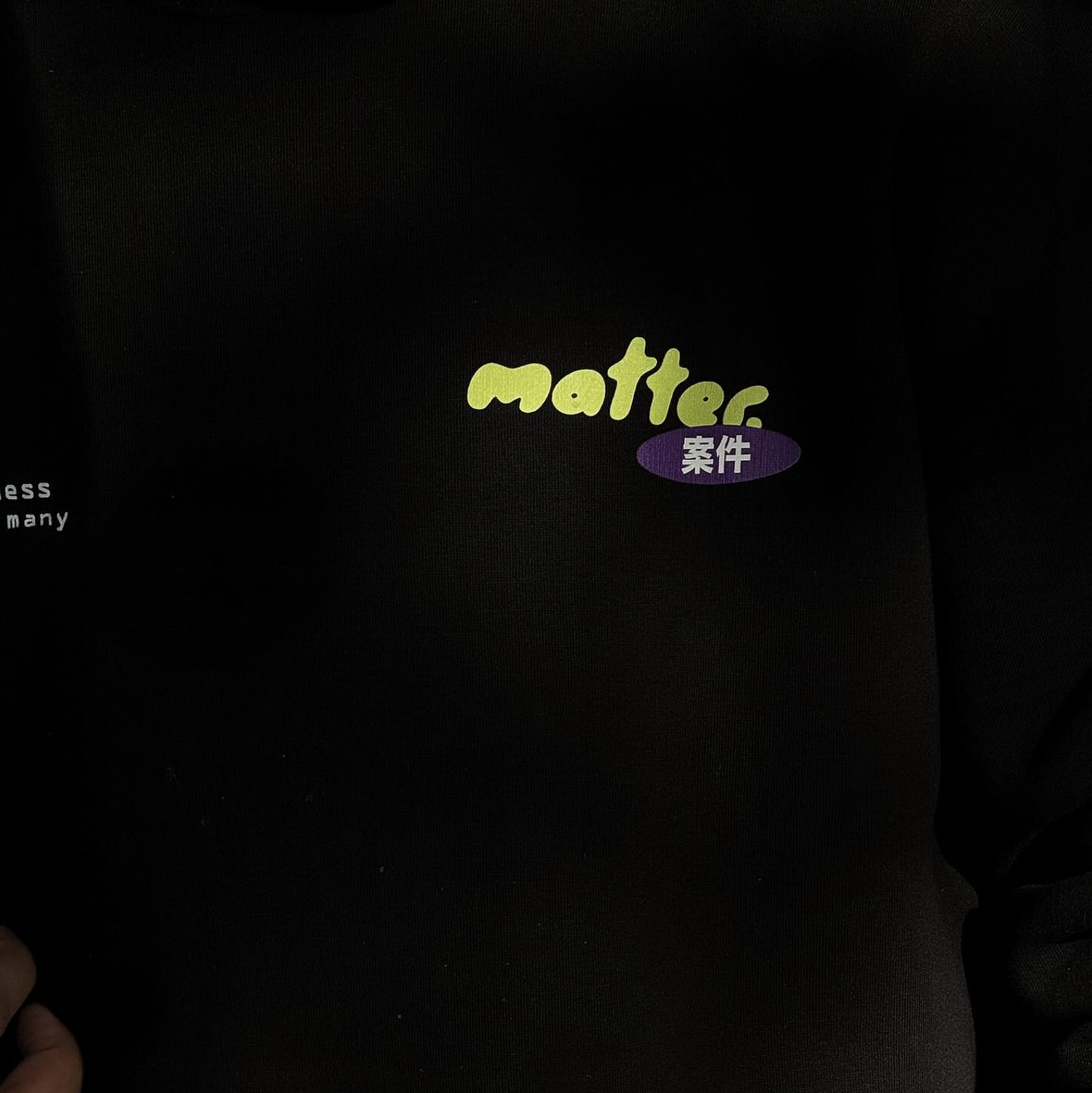 Black MATTER sweatshirt with the acid-green wordmark above a purple oval containing Japanese characters.